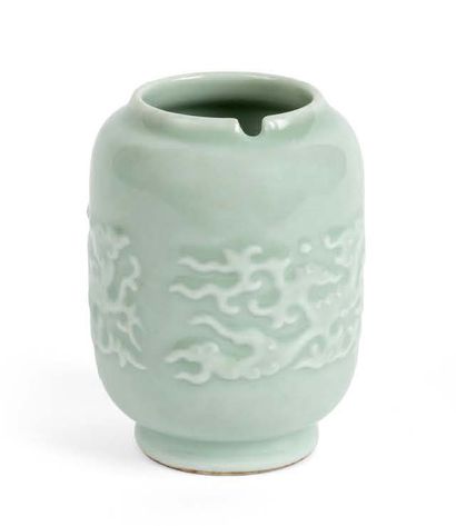 null A small cylindrical porcelain and celadon enamel vase, decorated in light relief...