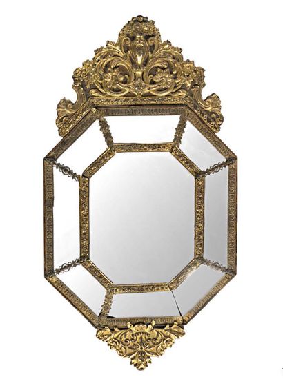  A stamped and patinated brass mirror with bouquets, palmettes and rocaille decorations....