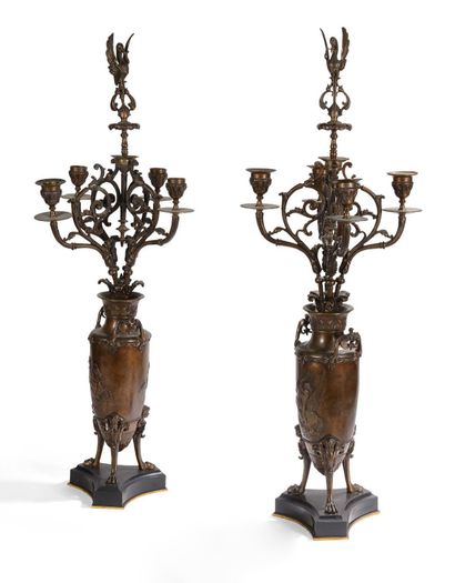  A pair of chased bronze torches with brownish-brown patina. Decorated with amphoras,...