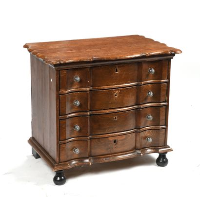 null Chest of drawers in molded and patinated fir wood opening by four drawers, the...