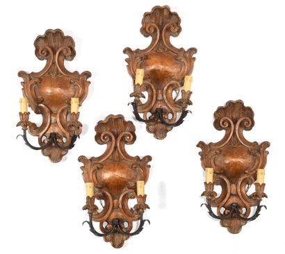 Suite of four sconces in carved and patinated...