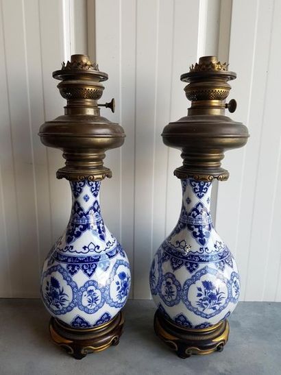 null Pair of ceramic oil lamp in bottle shape with white blue decoration, bronze...