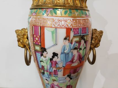 null A 19th century Canton porcelain kerosene lamp decorated with figures and flowers....