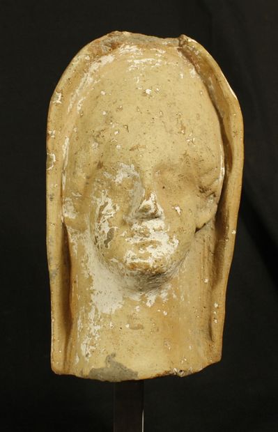 null Protome of a terracotta woman's head with traces of white slip. She is wearing...