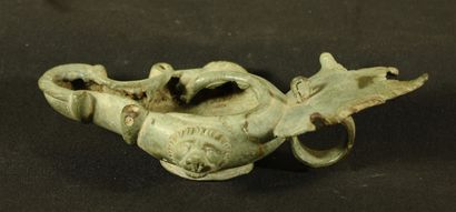 null Oil lamp in bronze with triangular spout decorated with volutes and leaf-shaped...