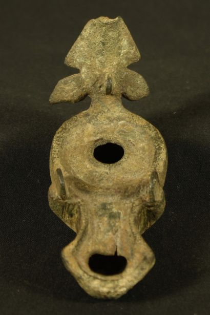 Bronze oil lamp with triangular spout decorated...