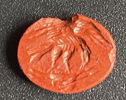 null Red jasper intaglio engraved with an eagle with its prey. The bird of prey,...