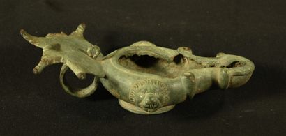 null Oil lamp in bronze with triangular spout decorated with volutes and leaf-shaped...