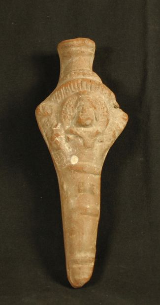 null Phallic beige terracotta object decorated with a bearded head, surrounded by...