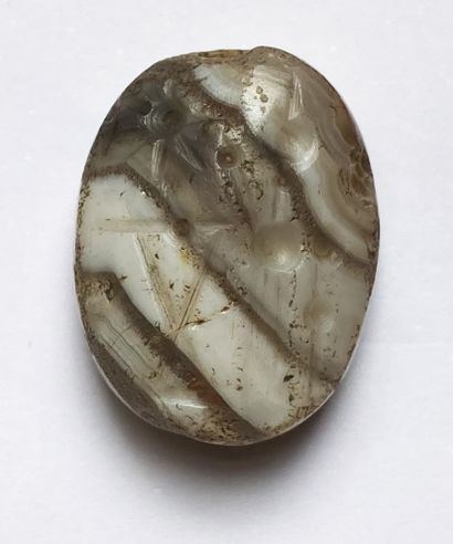 Ribboned agate seal engraved with a cult...