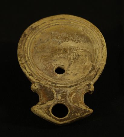 Terracotta oil lamp with triangular spout...