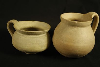 null Two pots with one handle in terracotta with cream slip. The body is ovoid and...