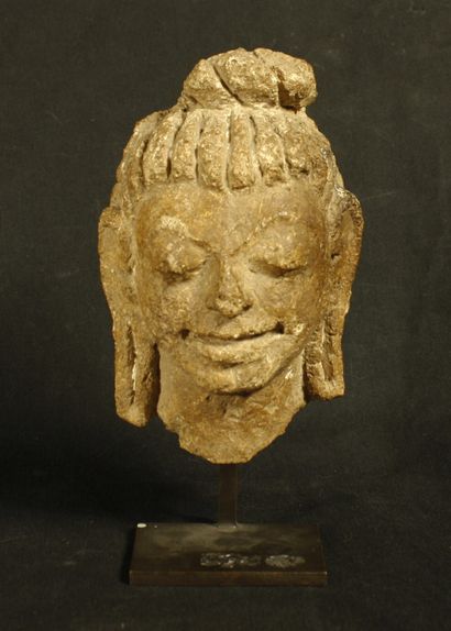  Head in stone. She is smiling, with her...