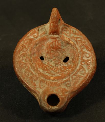 Terracotta oil lamp with round heart-shaped...