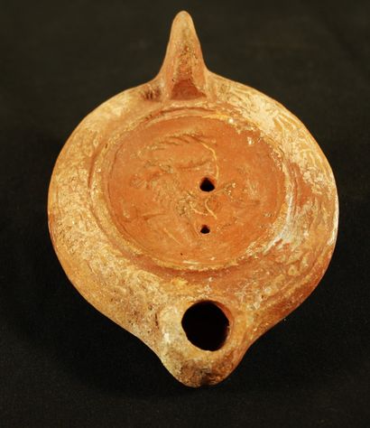 Red terracotta oil lamp with a heart-shaped...