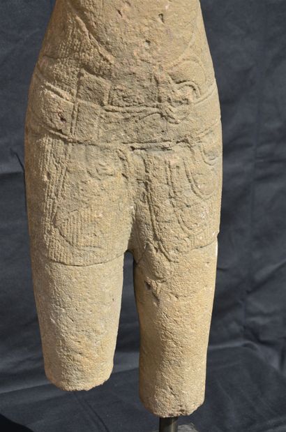 null 
Sandstone statue of an acephalous male deity represented standing in samabhanga....