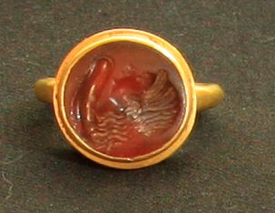 null Modern gold ring set with a carnelian intaglio engraved with a female head wearing...