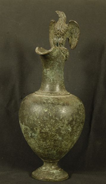 Ewer in bronze with green patina decorated...