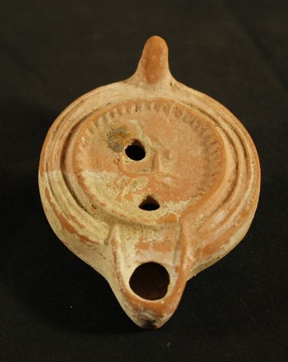 Oil lamp in red clay with curved channel...