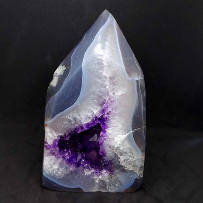  Amethyst geode on agate with bluish gray reflections made up of a set of translucent...