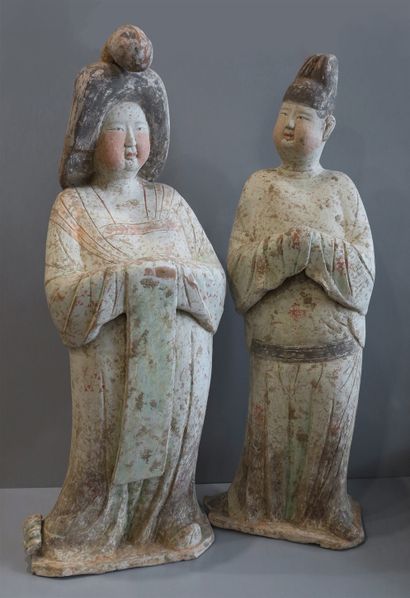  Pair of important mingqi, a couple of a lady and a court man represented standing...