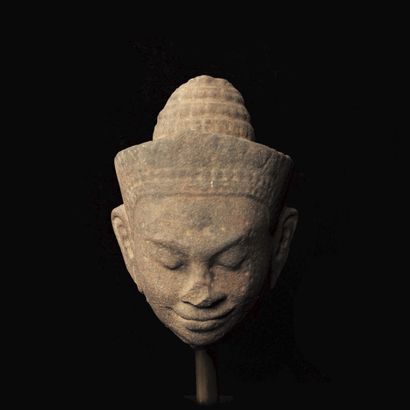 Head of Vishnu wearing a conical tiara set...