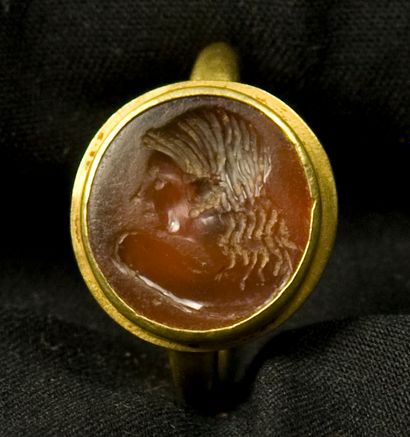 null Modern gold ring set with a carnelian intaglio engraved with a female head wearing...