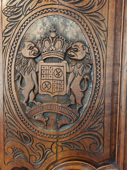 null Cabinet with pair of doors in natural wood molded and richly carved with crowns...