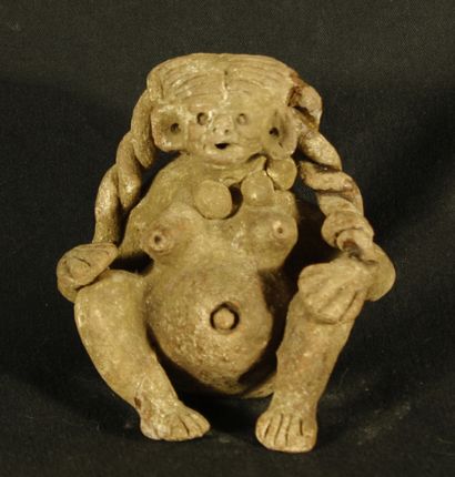 null Naked woman in terracotta represented with a rounded belly whose prominent navel...