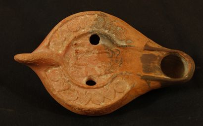 null Oil lamp in terracotta covered with a red brown decorated with two greyhounds...