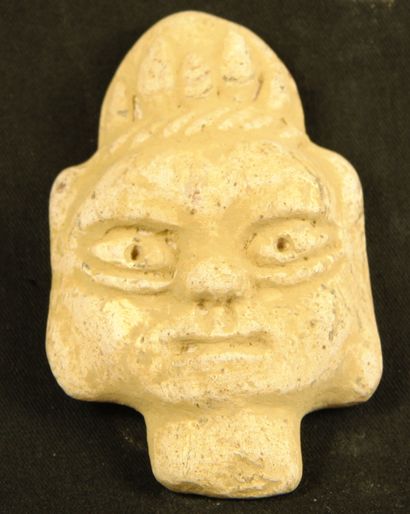 null White terracotta head with traces of glaze and flame hairstyle.
Vietnam, Tran...