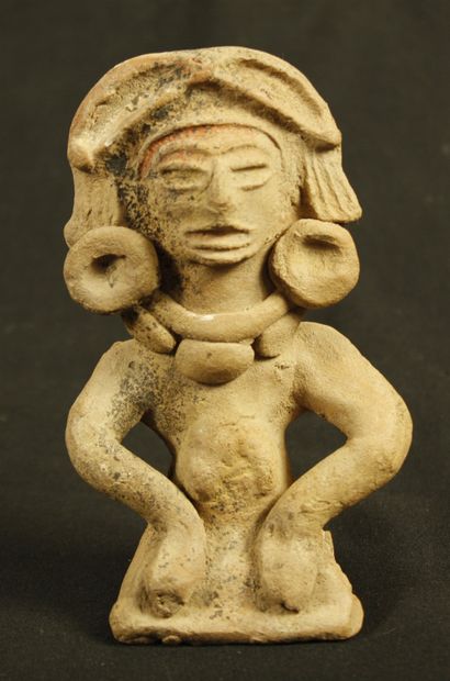 null Beige terracotta statuette with ochre slip representing a shaman seated cross-legged...