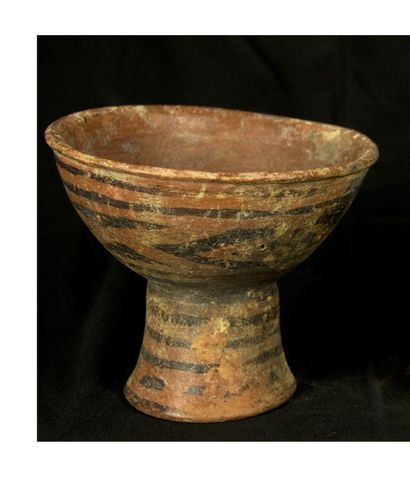 null Cup on flared foot in terra cotta with geometric decoration painted in black...