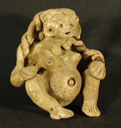 Femme nue en terre cuite représentée le ventre...
