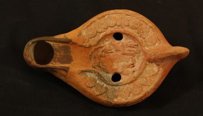 null Oil lamp in terracotta covered with a red brown decorated with two greyhounds...
