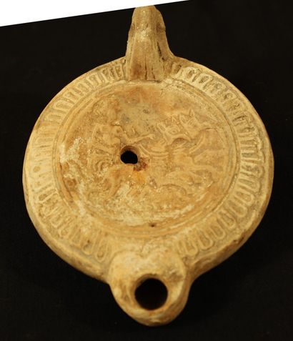 Terracotta oil lamp with heart-shaped spout...