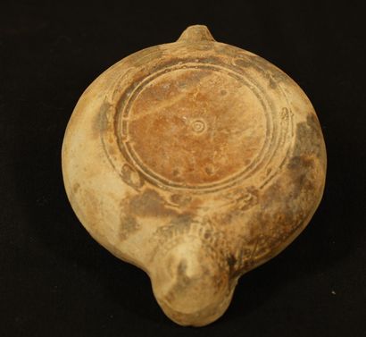 null Terracotta oil lamp with heart-shaped spout decorated with a chimera bige surrounded...
