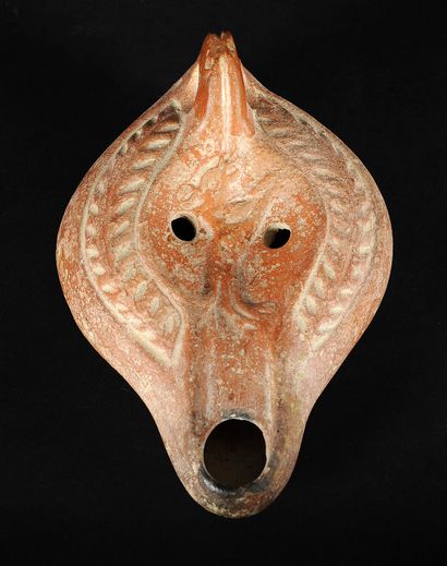 Red terracotta oil lamp with curved channel...
