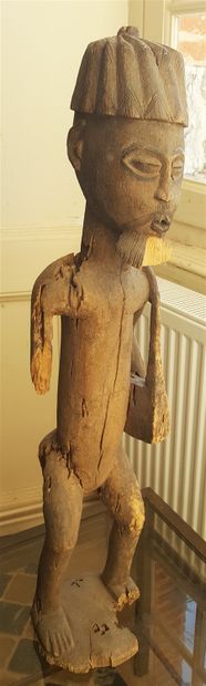 Wooden statuette representing a man wearing...