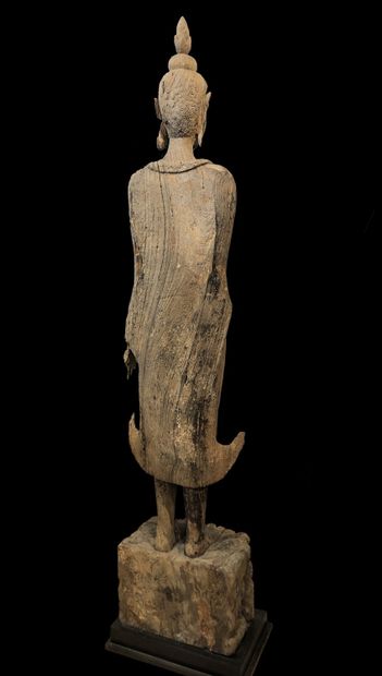 null Rare ravined wood Buddha represented standing on a pedestal decorated with a...