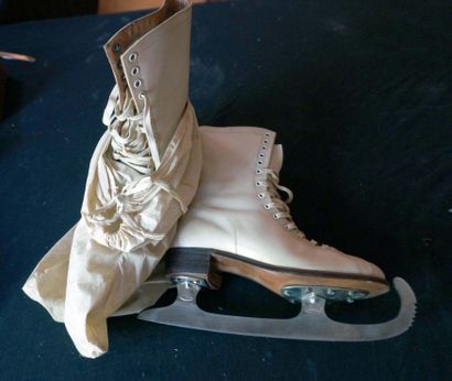 Pair of beige leather slippers and ice skates....