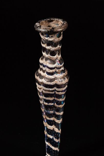 null Thin amphoriscal bottle in iridescent glass with wave motifs in highlights,...
