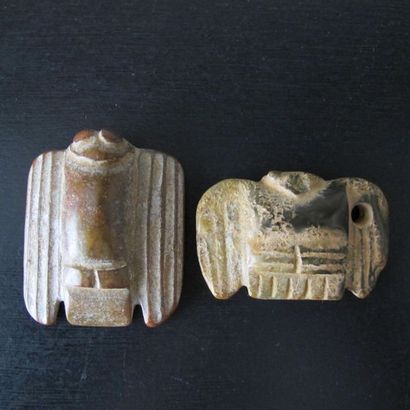 null Set of two amulets with nocturnal birds of prey. Nephrite jade partly calcified....