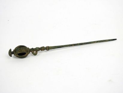 Large pin with cage bell at its end

Bronze...