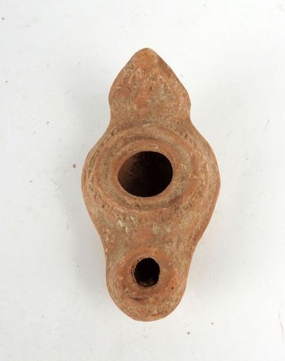 null Rare oil lamp with an amphora and geometric circular decoration.

Terracotta...