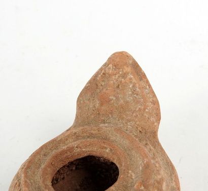 null Rare oil lamp with an amphora and geometric circular decoration.

Terracotta...
