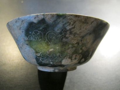 null Bowl decorated with Buddhist fan motifs. Translucent green steatite, reminiscent...