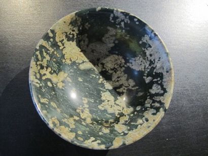 null Bowl decorated with Buddhist fan motifs. Translucent green steatite, reminiscent...