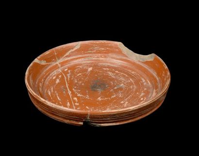 null Four terracotta dishes, including a cup, a fragment of Roman sigillata pottery...