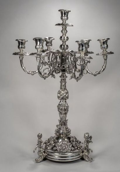 null Pair of seven-arm candelabra in silver resting on a round base decorated with...